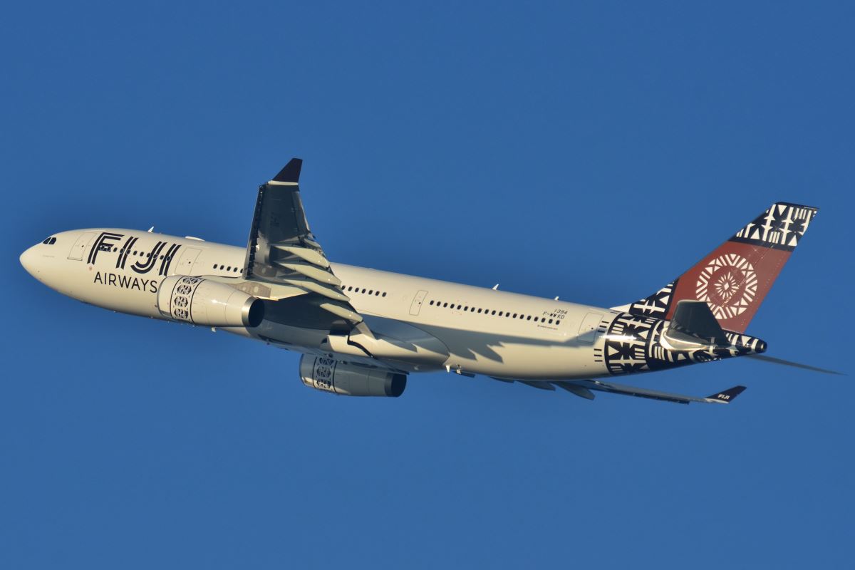 a white airplane flying in the sky