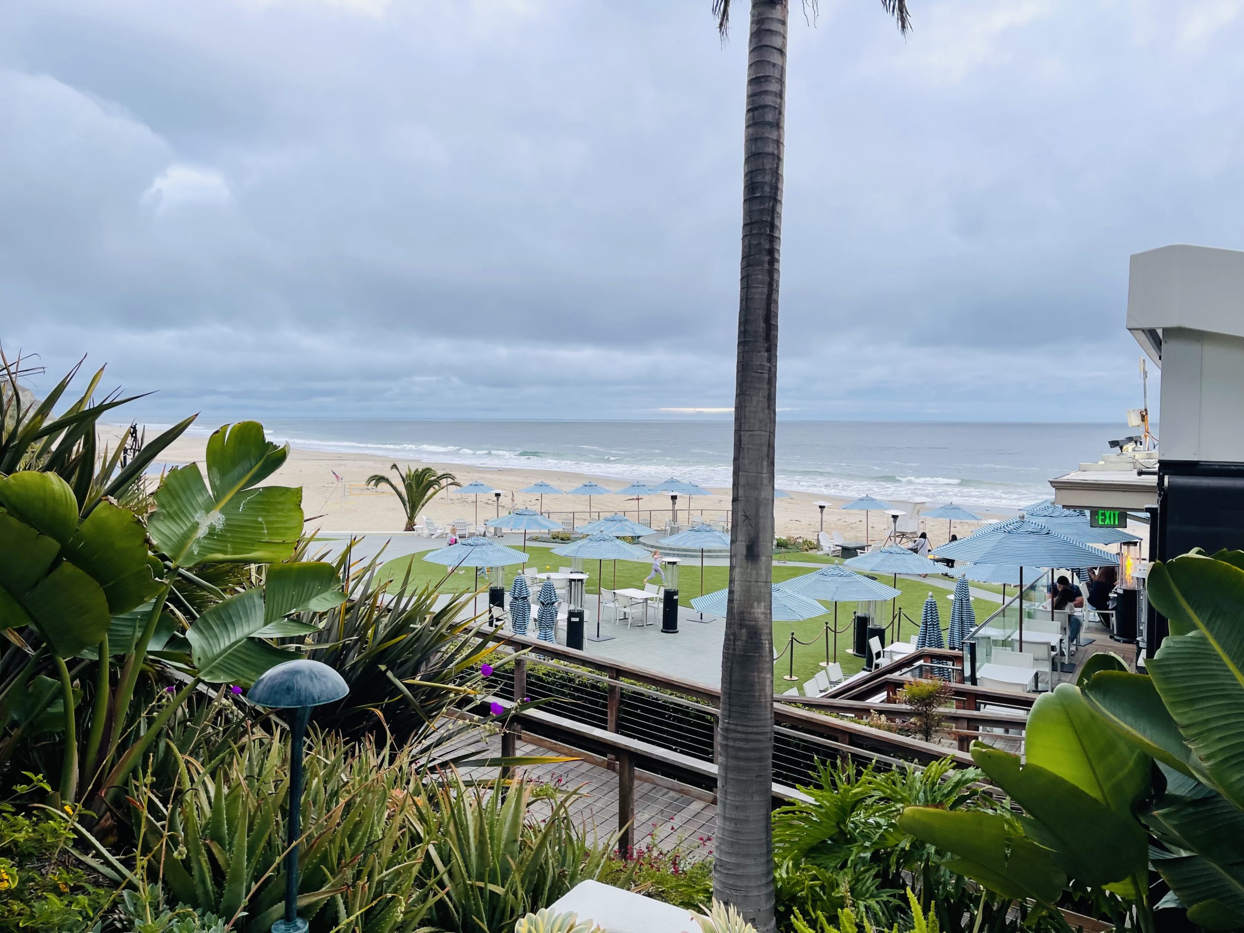 a beach with umbrellas and chairs