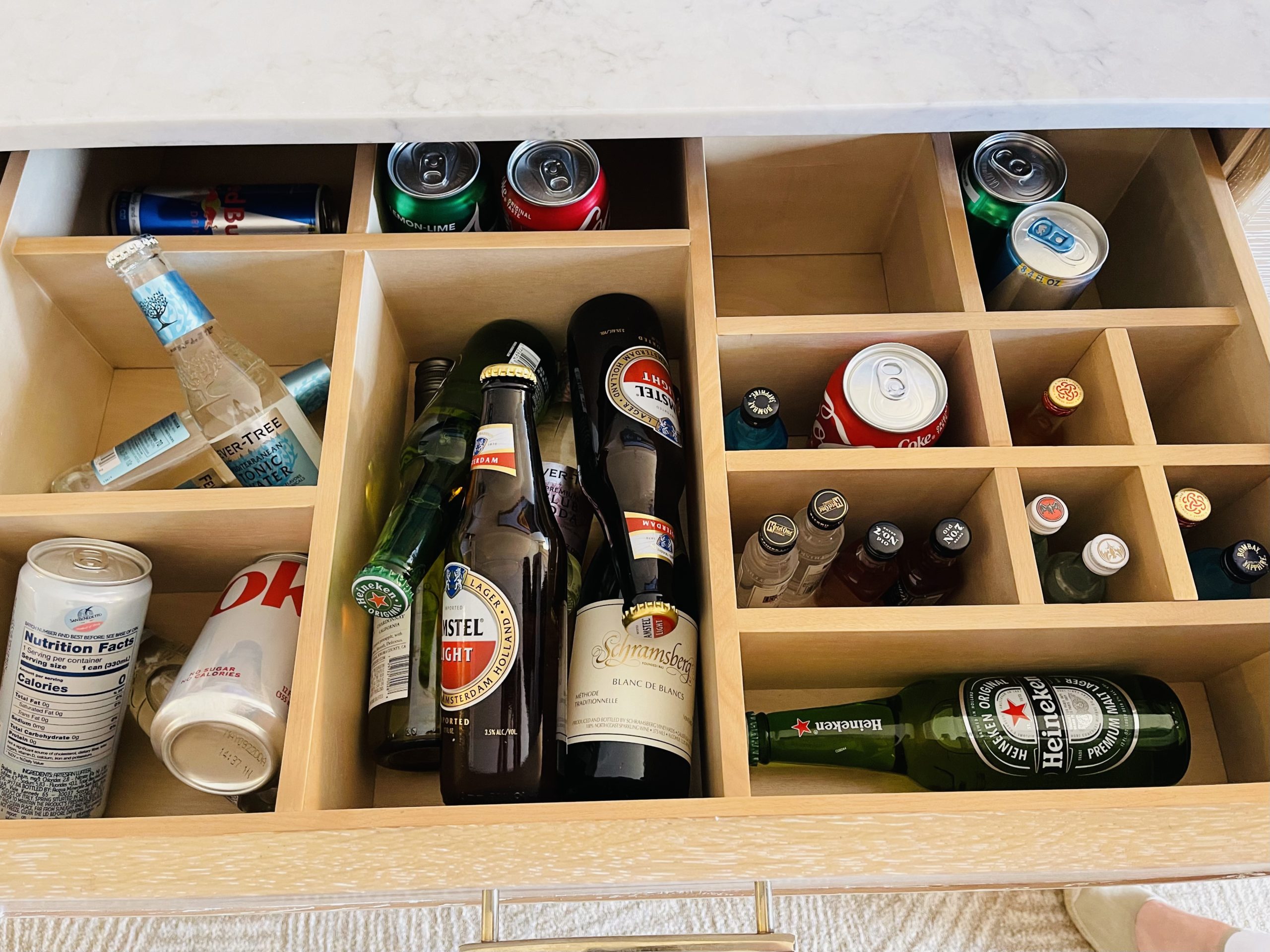 a shelf with bottles and cans in it