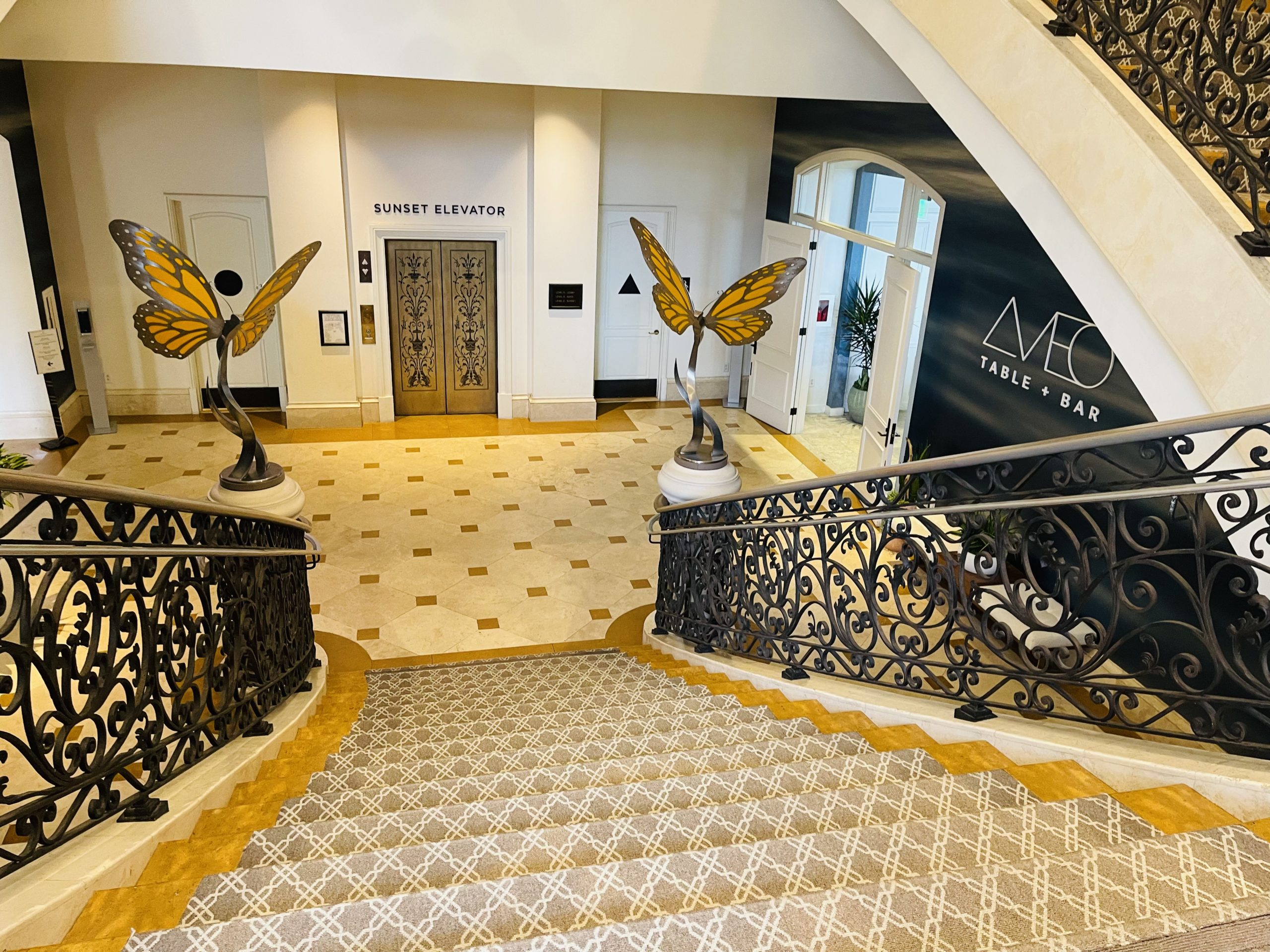 a staircase with a pair of butterflies statues