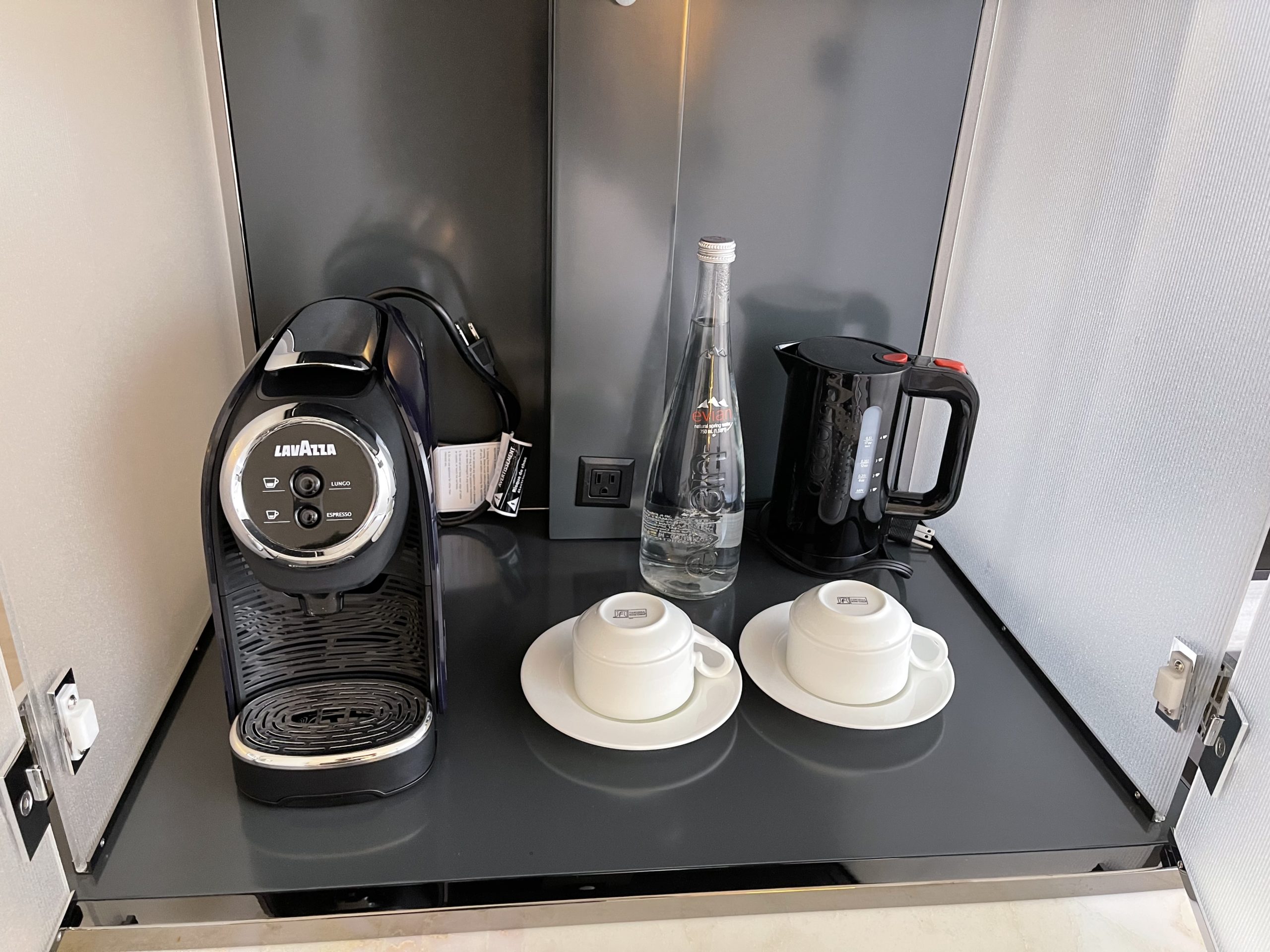 a coffee machine and a bottle of water on a table