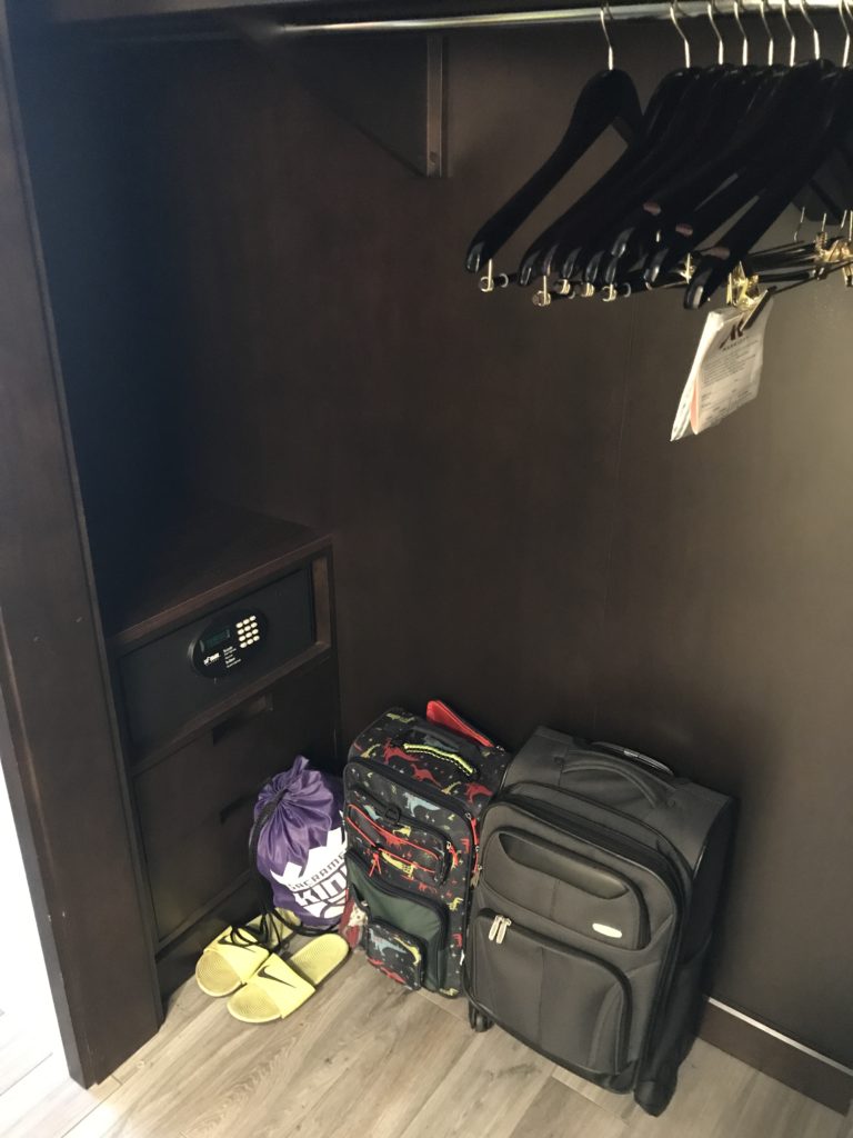 a closet with luggage and swingers