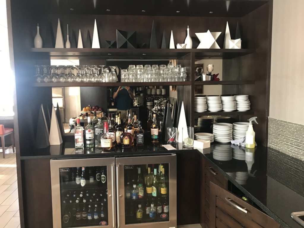 a bar with a variety of drinks and glasses