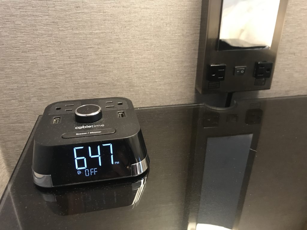 a digital alarm clock on a table