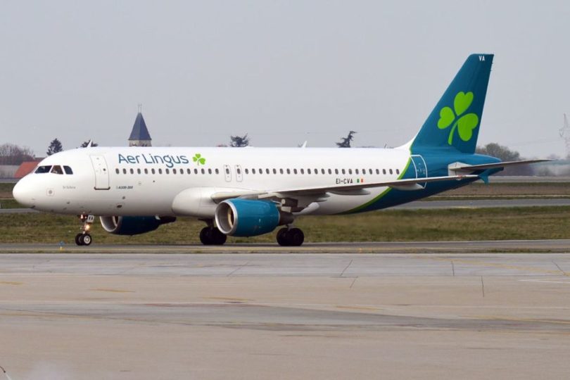 a white and blue airplane on a runway