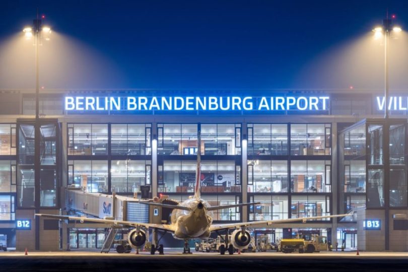 a plane parked in front of a building