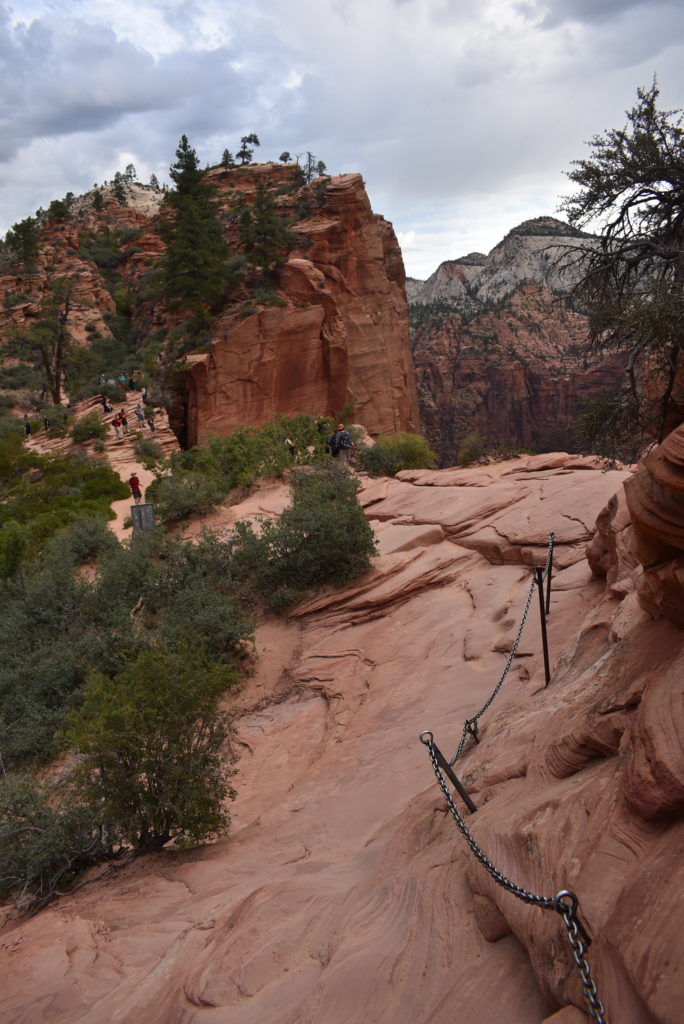 a group of people walking on a rocky trail