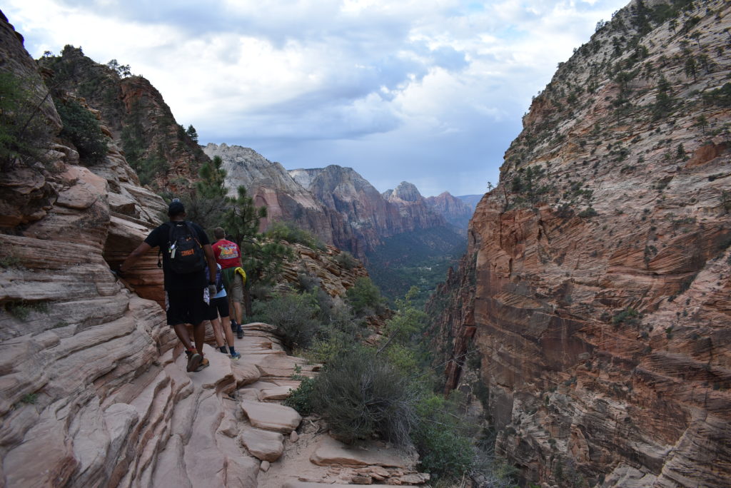 a group of people walking on a rocky trail