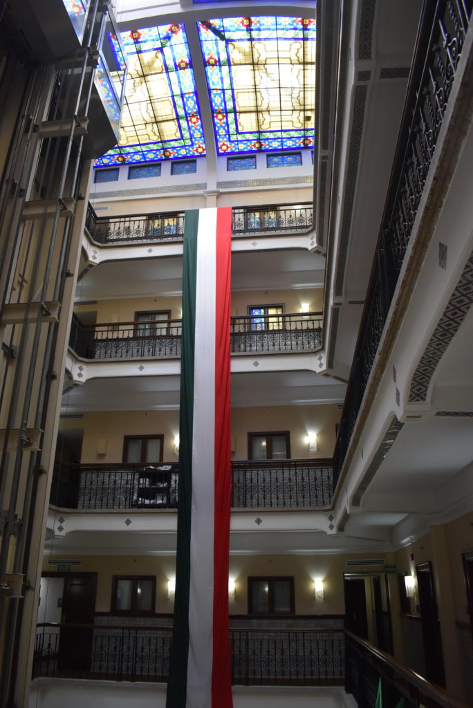 a multi story building with a flag from the ceiling