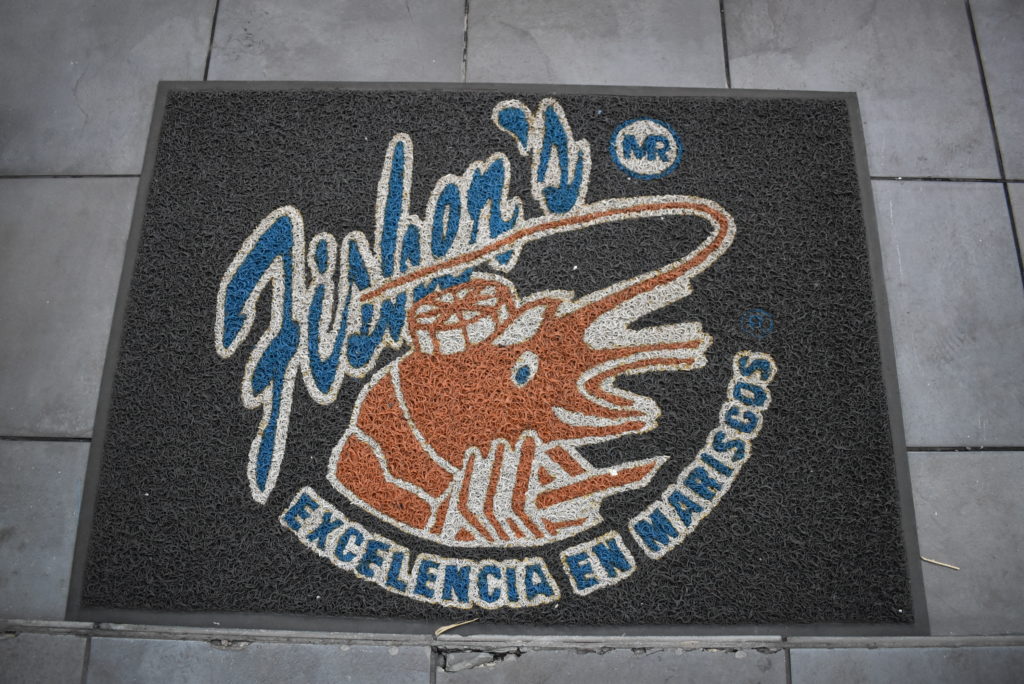 a black and blue doormat with a cartoon character on it