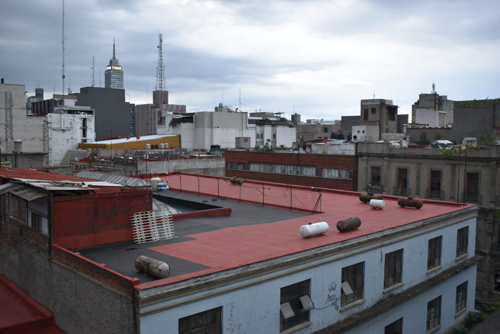 a rooftop of a building with many other buildings