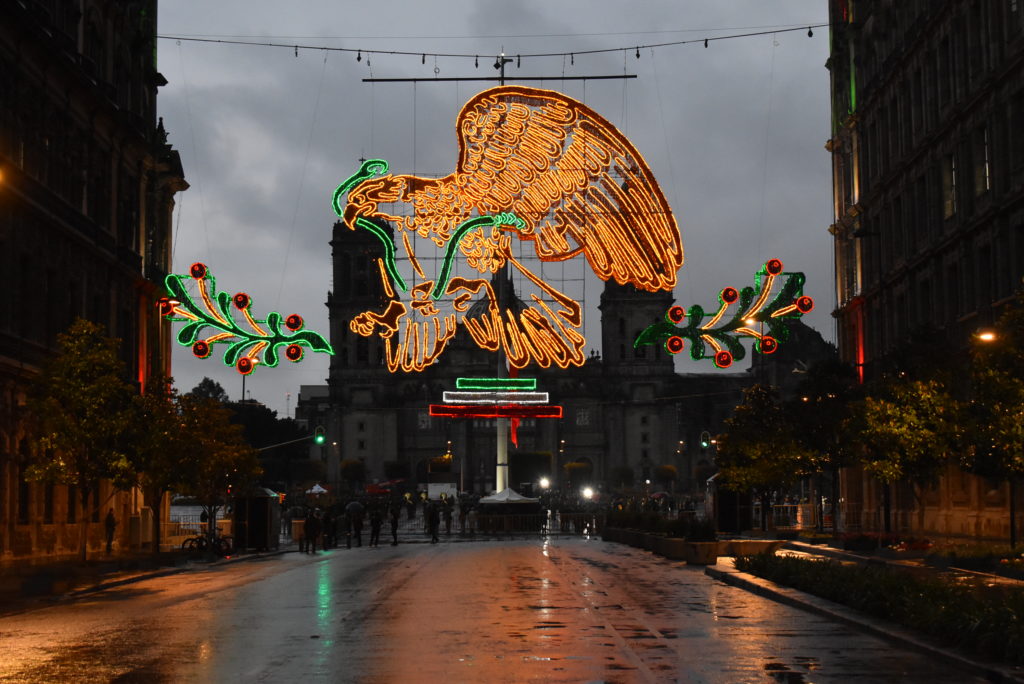a street with a large eagle and lights