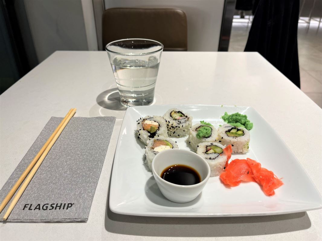 a plate of sushi and a glass of water