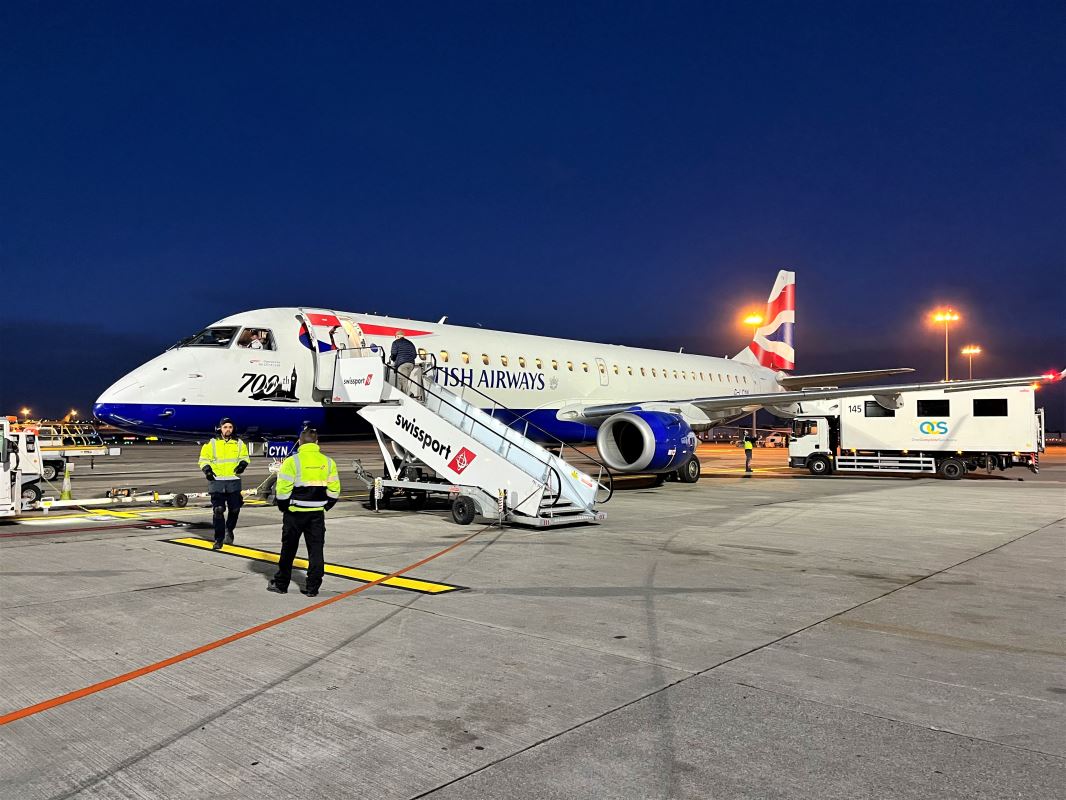 a group of people standing next to an airplane