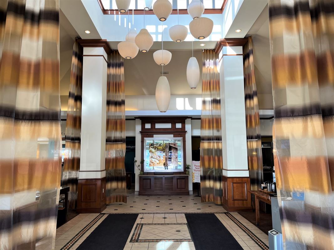 a hallway with a light fixture from the ceiling