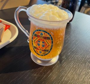 a glass of beer with foam in it