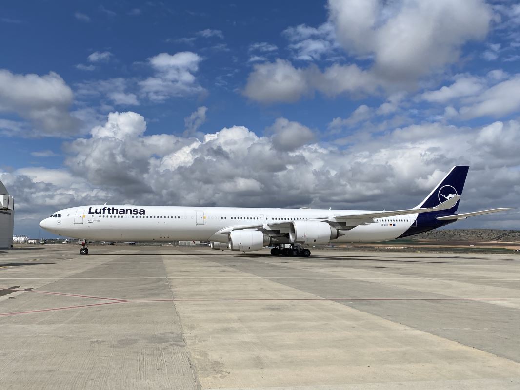 a large white airplane on a runway