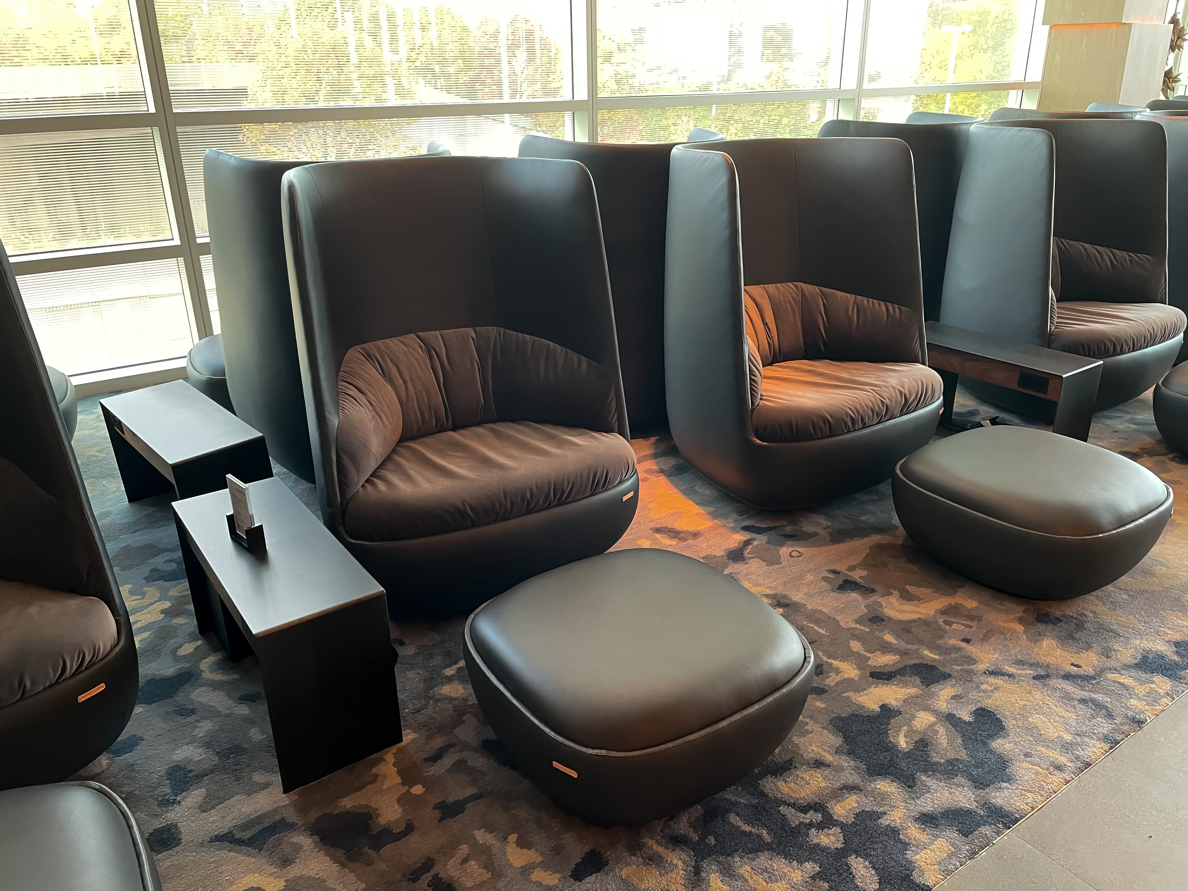 Booth-like seating with ottomans ideal for a quick rest before your next flight.