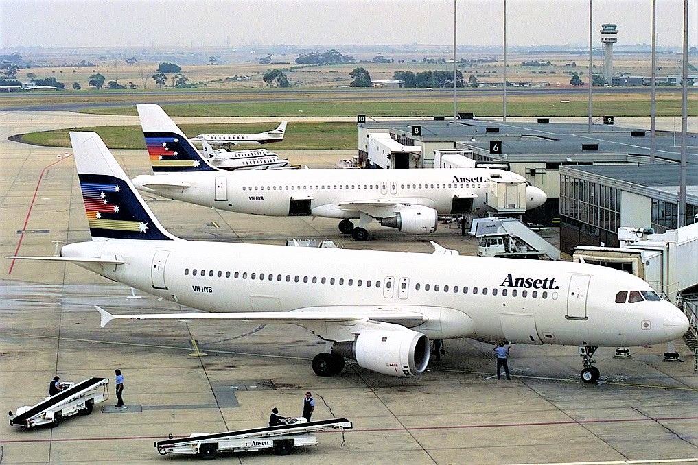 a group of airplanes at an airport