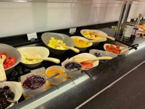 a group of bowls of fruit and berries