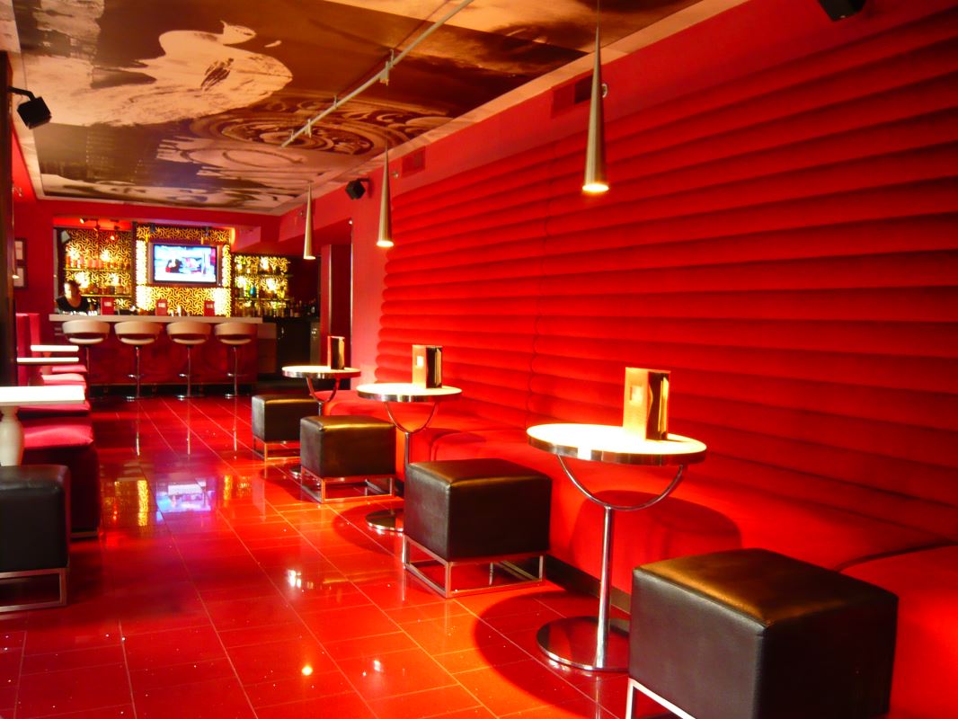 a red room with tables and chairs