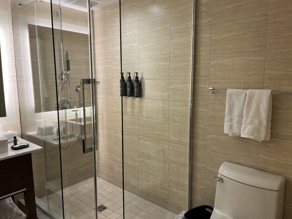 a bathroom with glass shower doors and toilet
