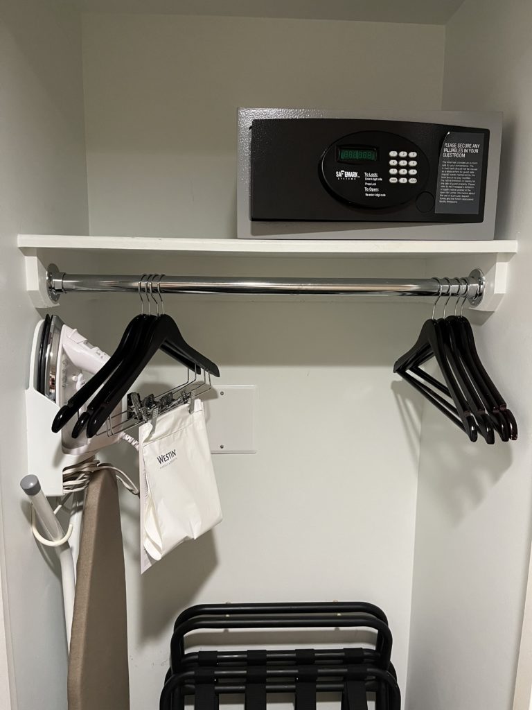 a closet with a digital lock and swingers