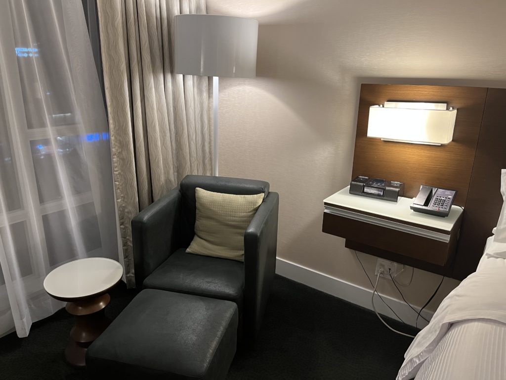 a chair and a lamp in a hotel room