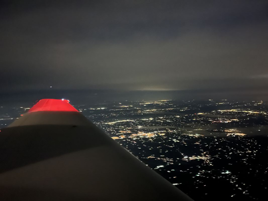 an airplane wing with a red light on the wing