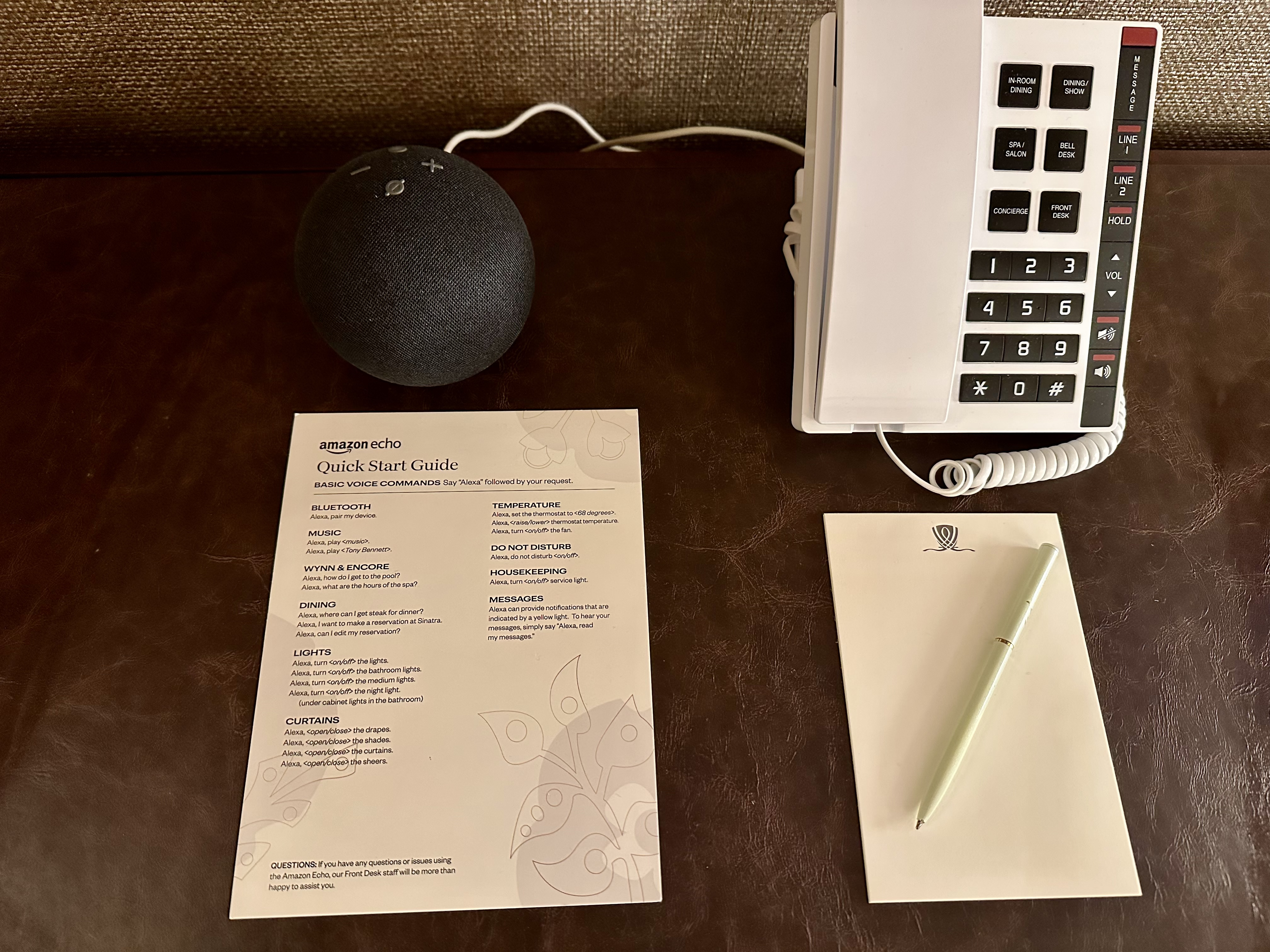 a telephone and a pen on a desk