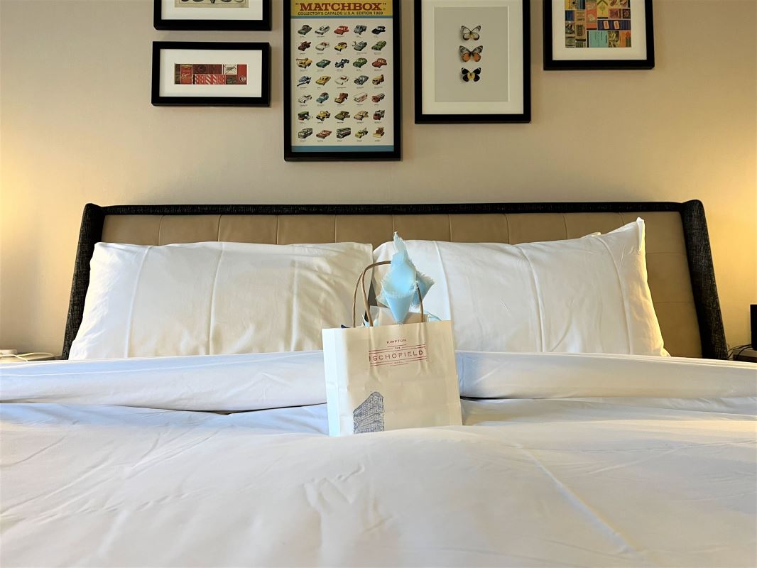 a white bag on a bed