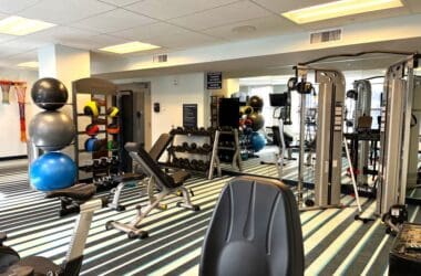 a room with exercise equipment and a mirror