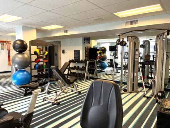 a room with exercise equipment and a mirror