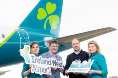 a group of people holding signs in front of an airplane