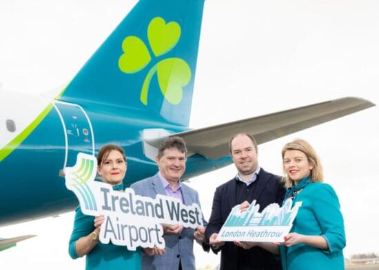 a group of people holding signs in front of an airplane