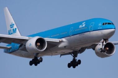 a blue and white airplane in the sky