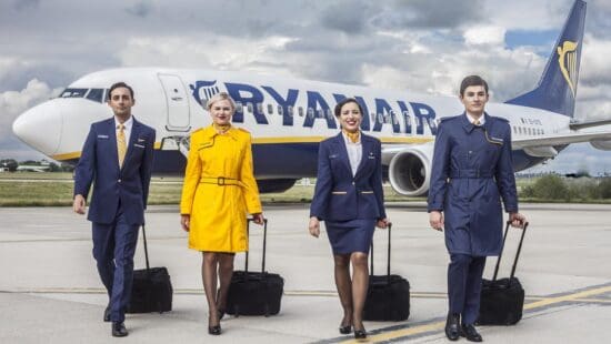 a group of people in uniform with luggage