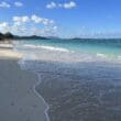 a beach with waves crashing on the shore