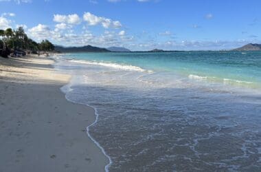 a beach with waves crashing on the shore