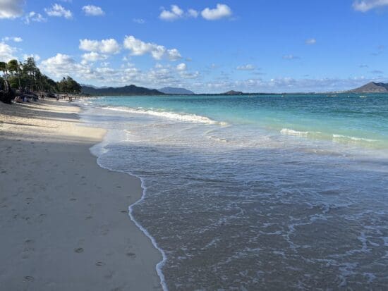 a beach with waves crashing on the shore