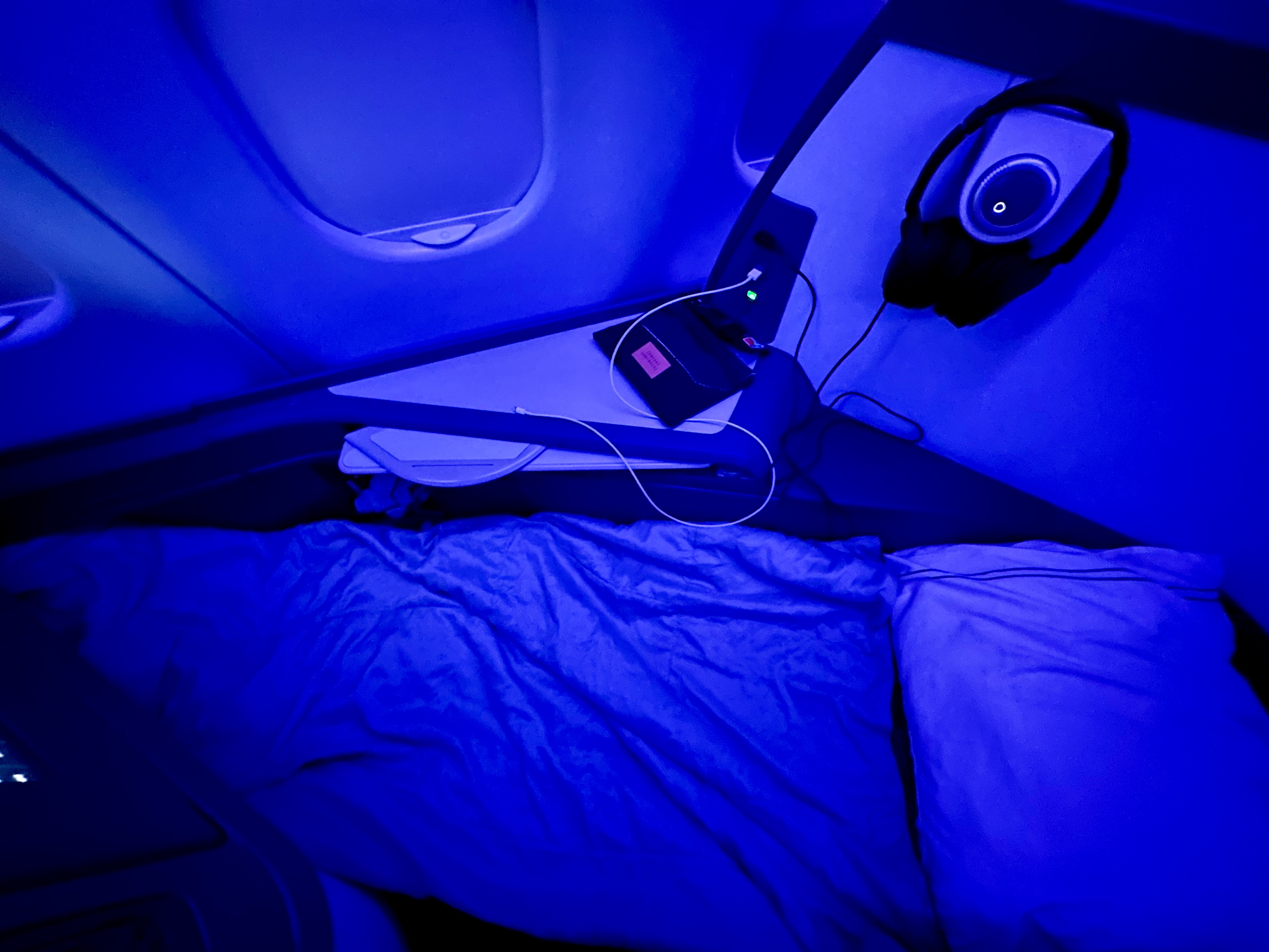 a bed with headphones and a speaker on it