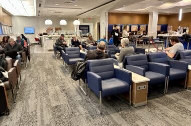 a group of people sitting in chairs in a waiting room