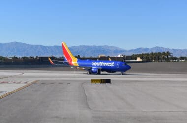 a blue airplane on a runway