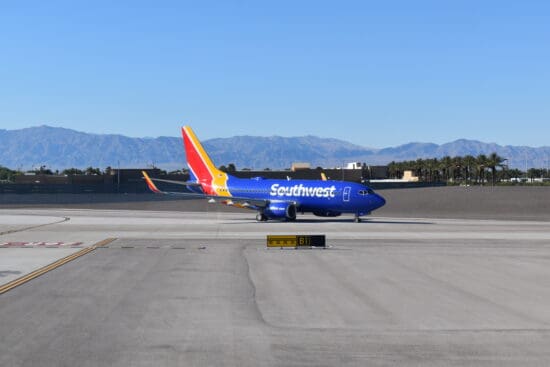 a blue airplane on a runway