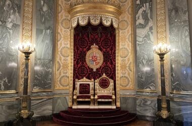 a throne in a room with marble walls and a marble floor