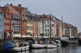 boats on the water next to buildings