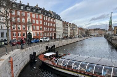 a boat on a river with buildings in the background