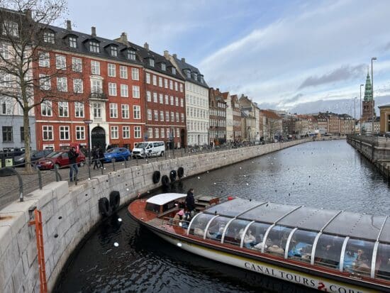 a boat on a river with buildings in the background