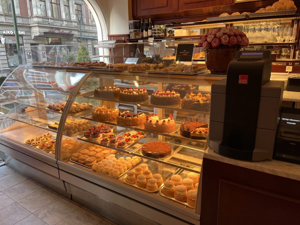 a display case with cakes and desserts