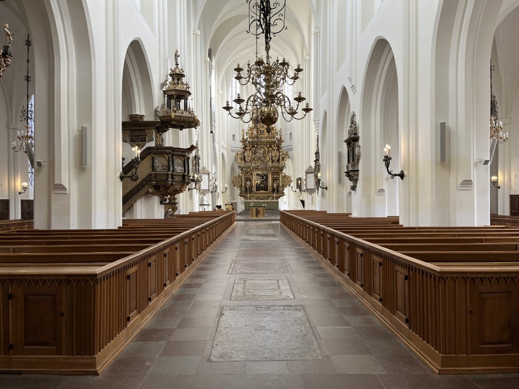 a church with pews and chandeliers